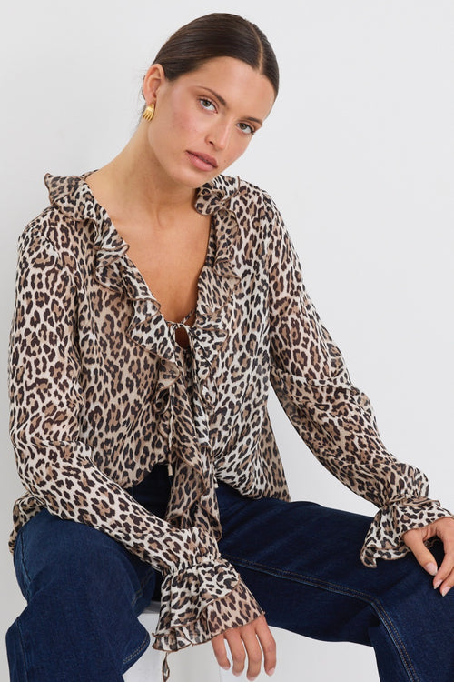 model wears a brown leopard with blue jeans