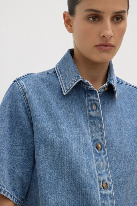 Model wearing denim shirt. 