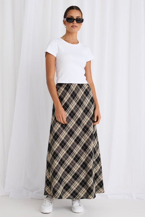 model wears a black gingham maxi skirt