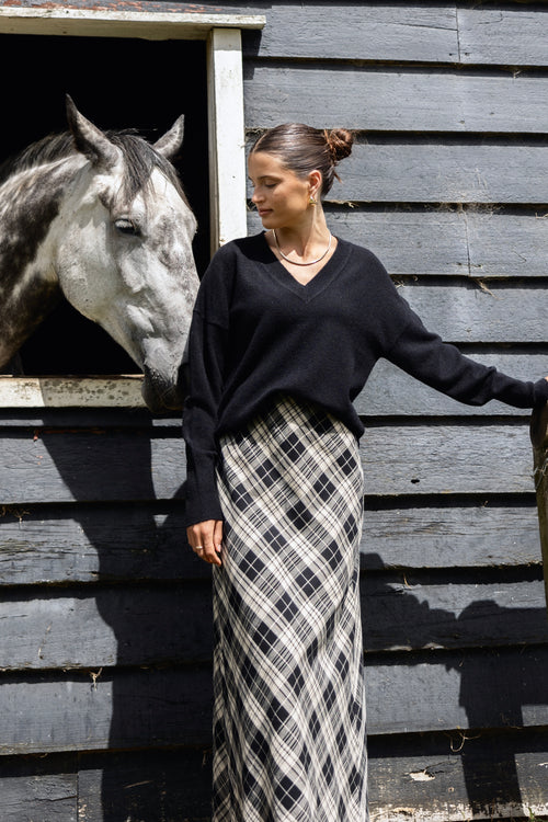 model wears a black gingham maxi skirt