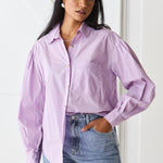 model wears purple button up long sleeve shirt and blue jeans