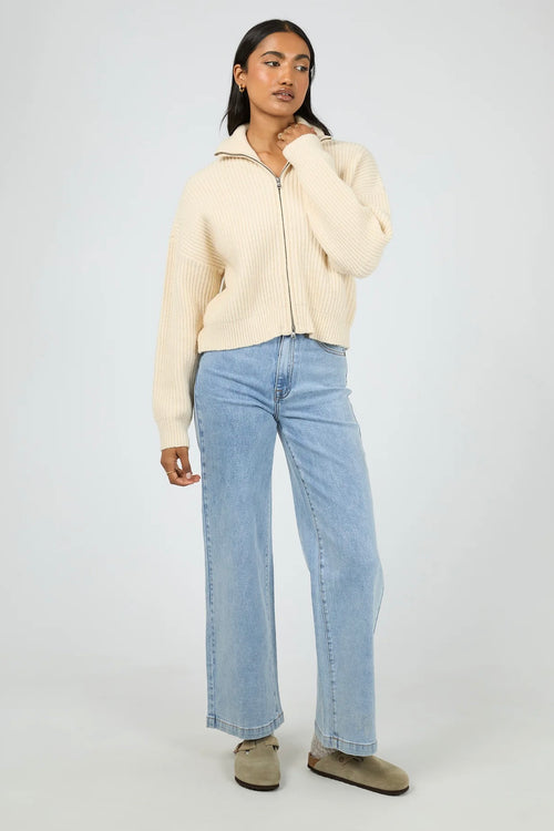 Model wears a vanilla long sleeve knit zip up cardigan