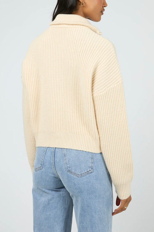 Model wears a vanilla long sleeve knit zip up cardigan