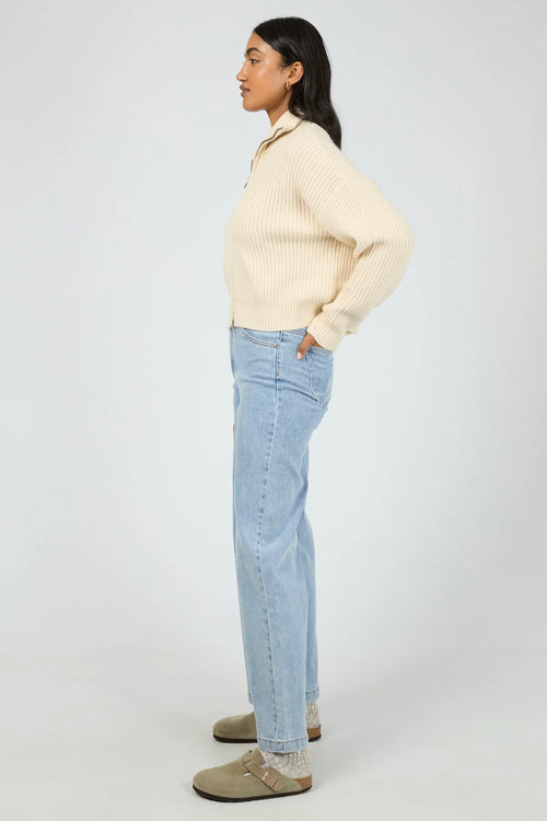 Model wears a vanilla long sleeve knit zip up cardigan