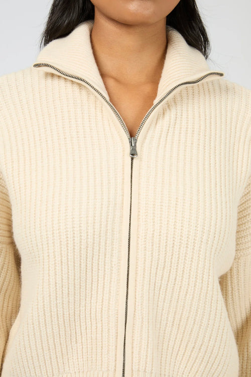Model wears a vanilla long sleeve knit zip up cardigan