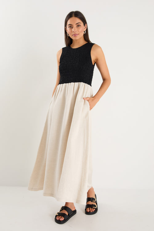 Woman wearing a black and beige dress on a white background