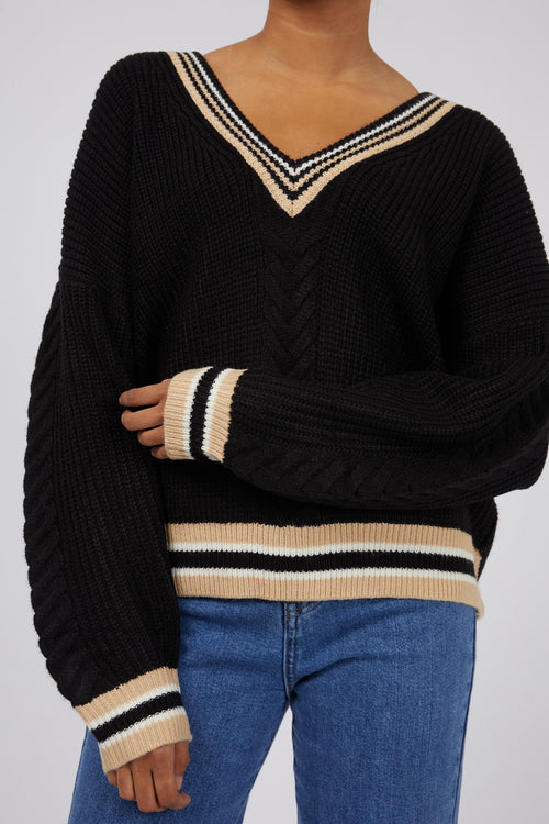 model wears a black knit