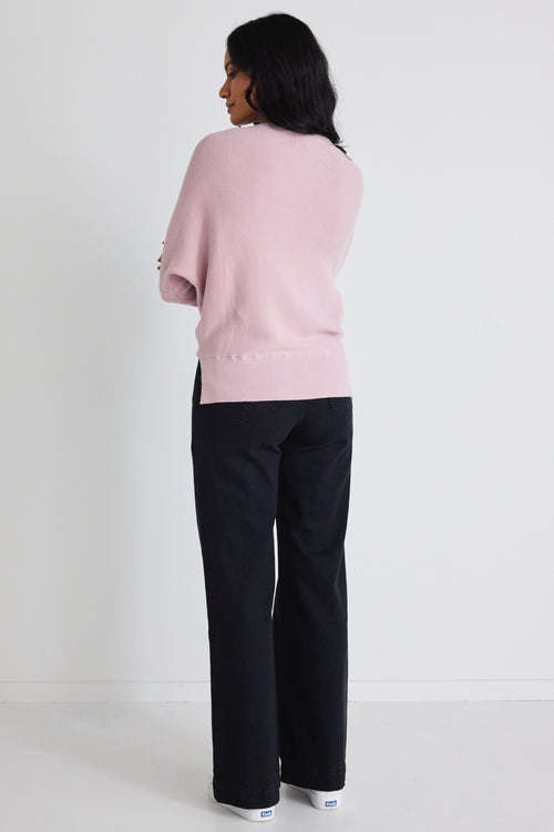 Model wears a pink batwing jumper