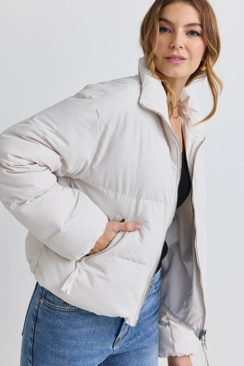 model wears a white puffer jacket