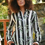 woman wearing a black white striped shirt with olive branches