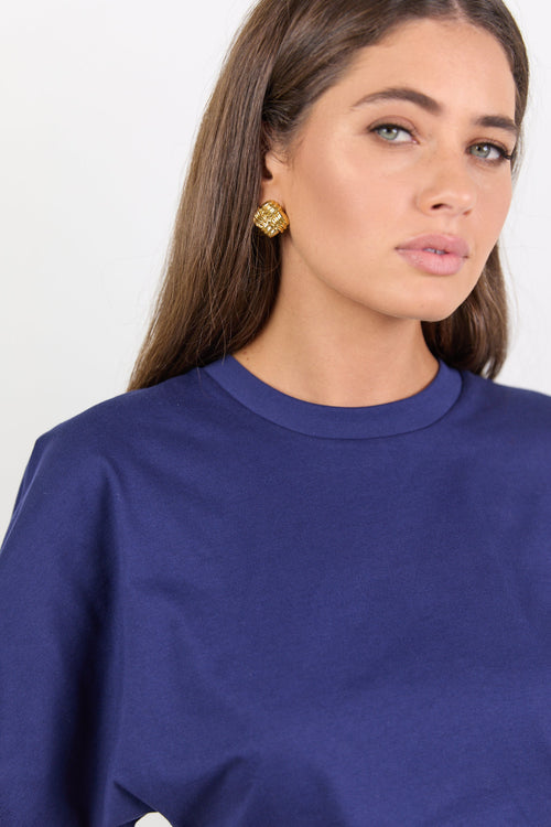 Woman wearing a blue shirt against a white background