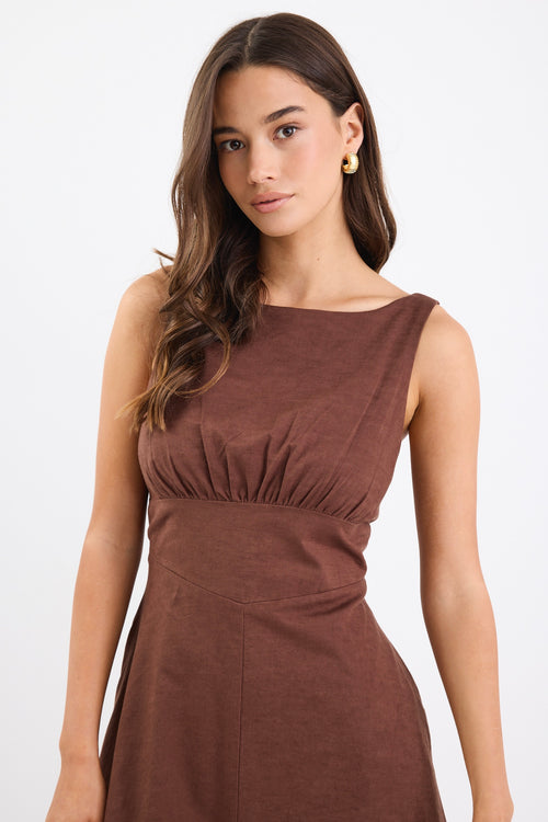 A chocolate brown dress with strappy sleeves and a shirred back for a flattering fit. Made from a breathable blend of 45% Linen and 55% Cotton, and fully lined for comfort.