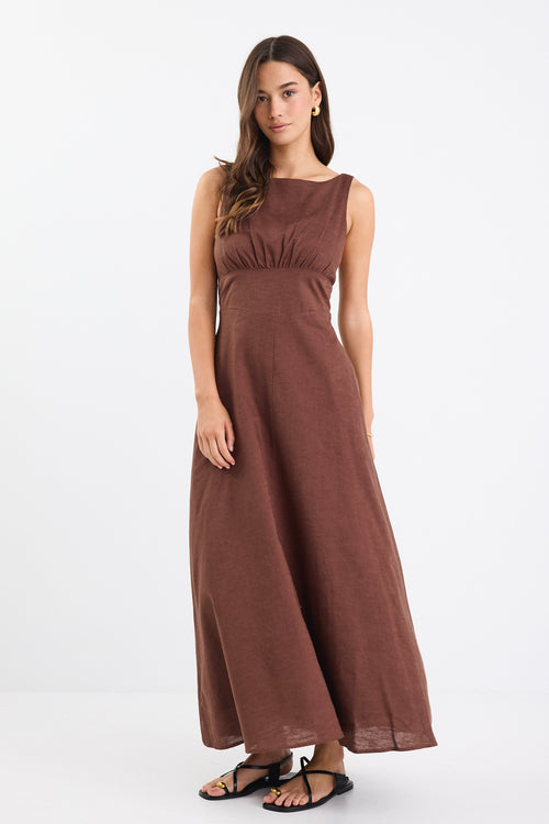 A chocolate brown dress with strappy sleeves and a shirred back for a flattering fit. Made from a breathable blend of 45% Linen and 55% Cotton, and fully lined for comfort.