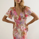 model wears pink floral dress