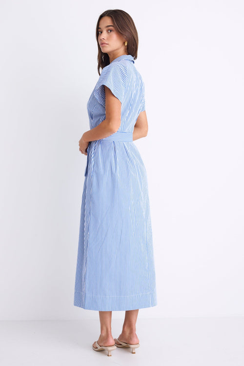 Woman wearing a bright blue striped midi shirt dress with short sleeves, button front, waist tie, and pleated skirt.