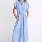 Woman wearing a bright blue striped midi shirt dress with short sleeves, button front, waist tie, and pleated skirt.