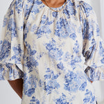 model wears blue floral top