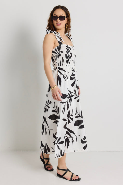 model wears a white and black maxi dress