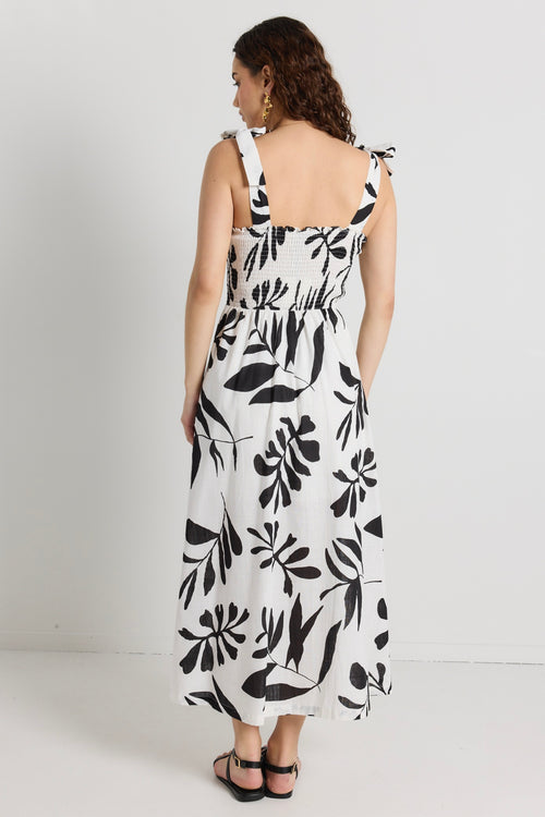 model wears a white and black maxi dress