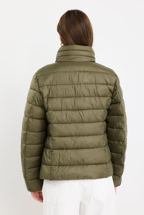 Person wearing a green puffer jacket on a white background
col_pattern