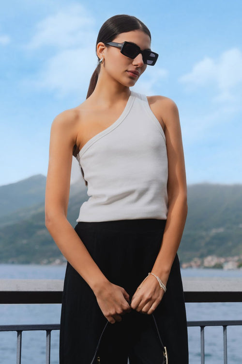 model wears one shoulder white tank top