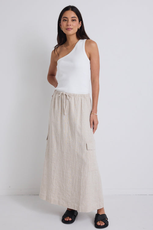 model wears natural linen maxi skirt and white one shoulder top