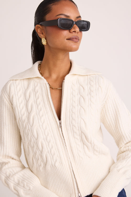 model wears a white knit zip jumper