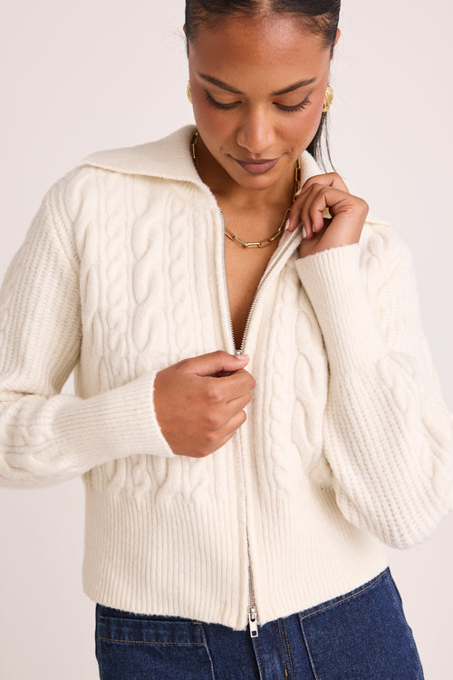 model wears a white knit zip jumper