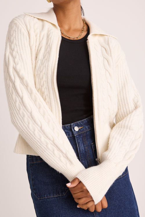 model wears a white knit zip jumper