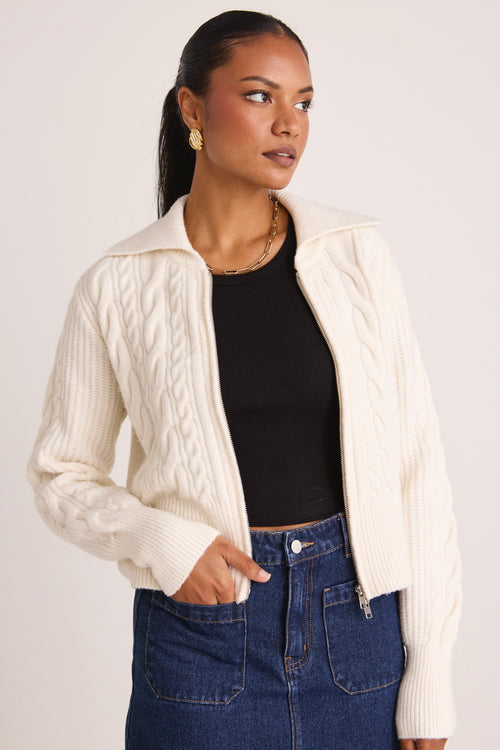 model wears a white knit zip jumper