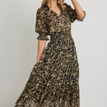 model wears a Black Gold Floral Midi Dress