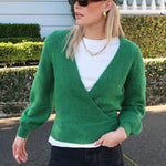 model wears a green knit