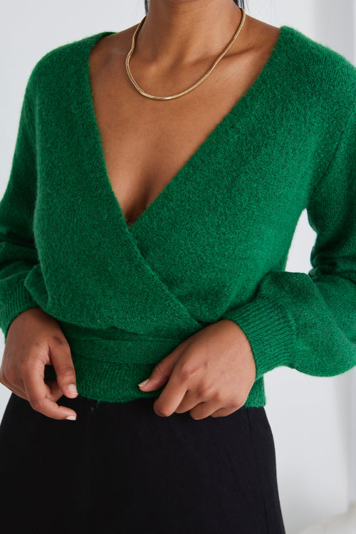 model wears a green wrap knit