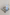 A light blue Stanley travel tumbler with a matching lid and a stainless steel tray, styled on top of a book in a neutral indoor setting.