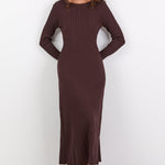 Woman wearing a brown dress against a white background