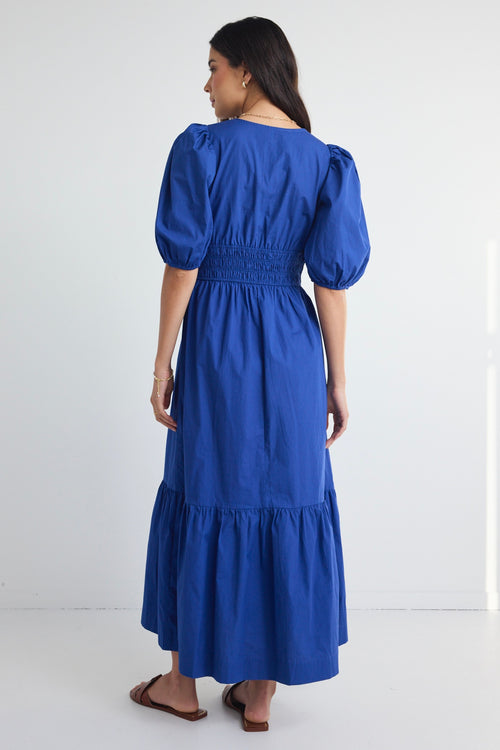 model wears a blue maxi dress