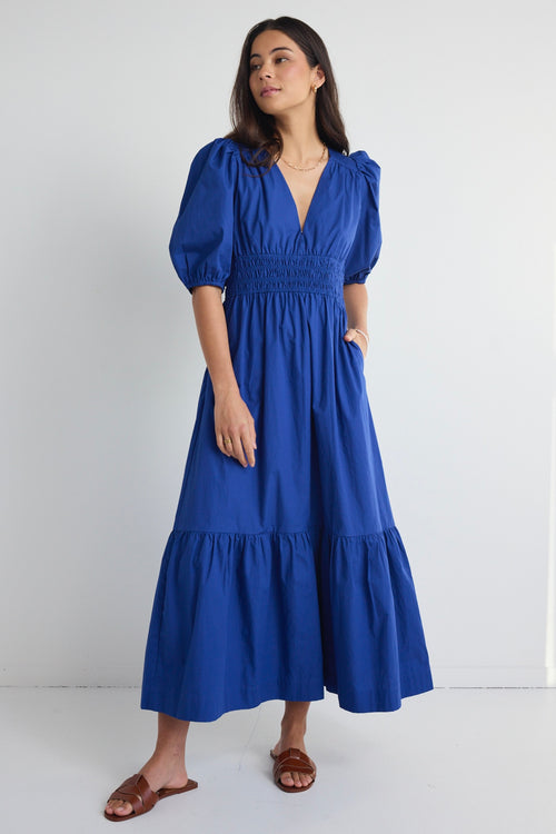 model wears a blue maxi dress