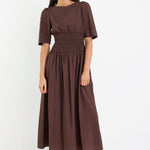 Woman wearing a brown dress on a white background