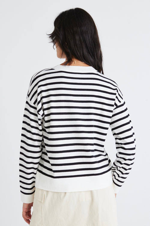 model wears a white stripe knit