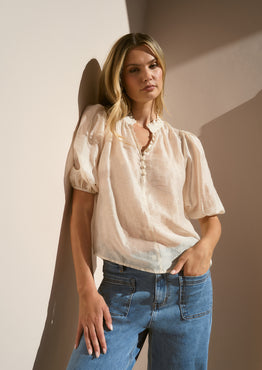 Model wearing a sheer ivory blouse
@col_pattern