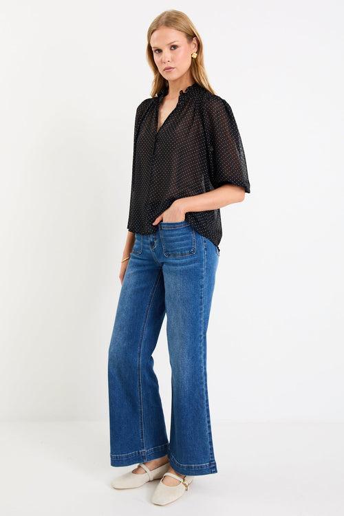 Woman wearing a black white polka dot top