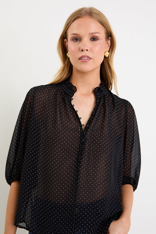 Woman wearing a black white polka dot top