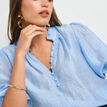 model wears a blue blouse