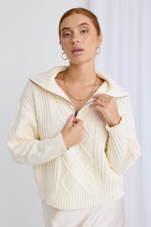 model wears a white knit jumper