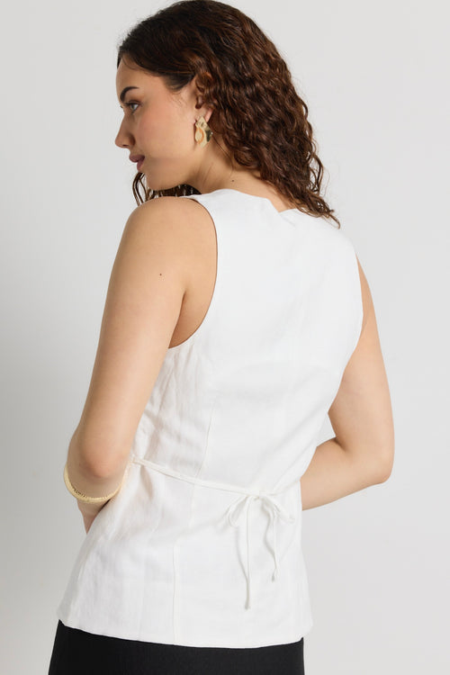 model wears a white linen vest