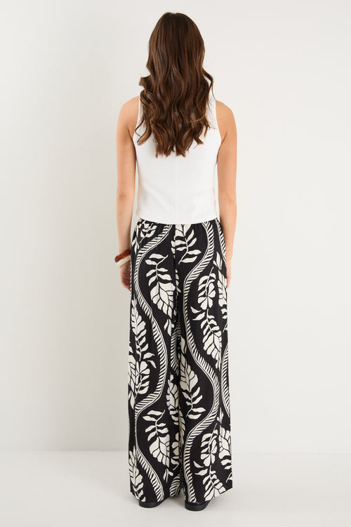 woman wearing black white pant and white top