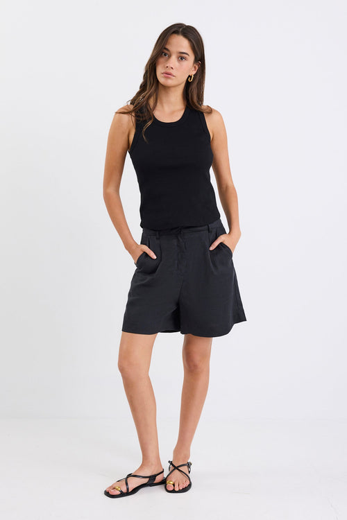 Woman wearing black linen. shorts and black tank