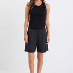 Woman wearing black linen. shorts and black tank