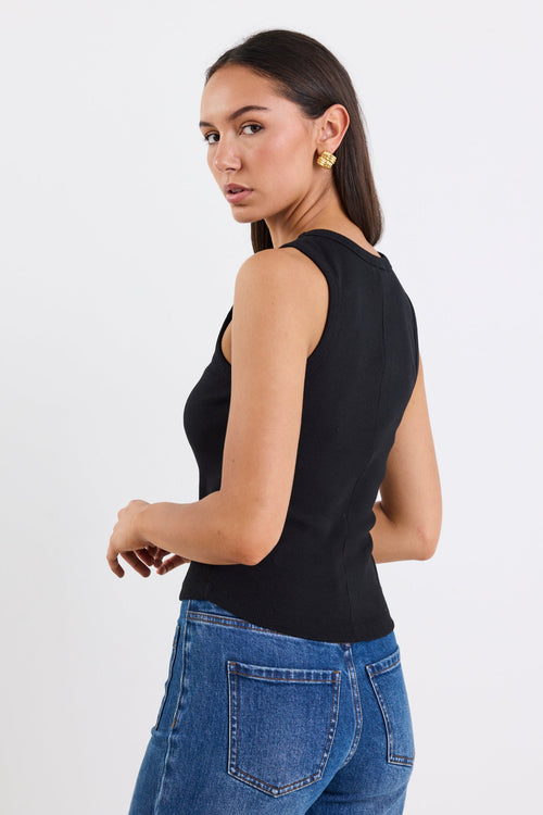 woman wearing black rib tank and blue jeans
