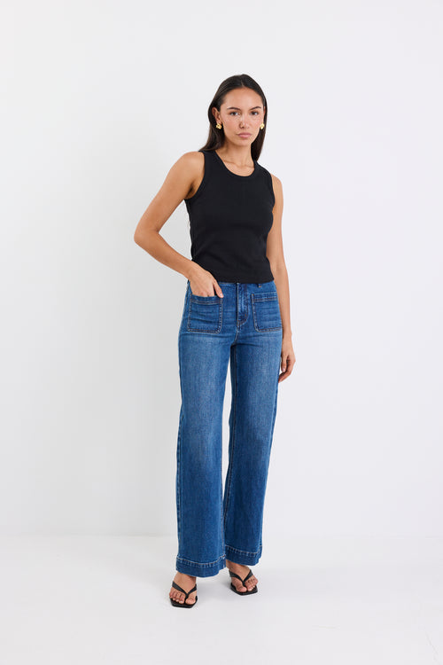 woman wearing black rib tank and blue jeans
